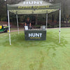 A HUNT Refined Repellent tent on a golf course.