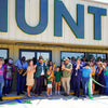 A photo of the ribbon cutting ceremony outside HUNT's new warehouse.