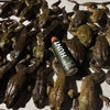 A bottle of HUNT Refined Repellent Spray on a table with bullfrogs.