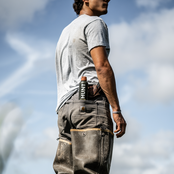 Farmer with HUNT Refined insect repellent that won't damage fishing line or rod finishes