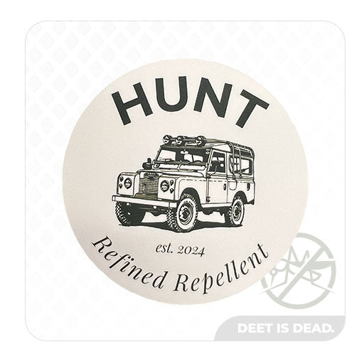 A product photo of the "HUNT Refined Repellent est. 2024" decal from the HUNT Refined Repellent Decal Four Pack. It is a decal featuring the words "HUNT Refined Repellent est. 2024" on a white background. There is a drawing of the company rover in the center.