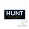 Sticker with 'HUNT Refined Repellent' text on a dark green background.
