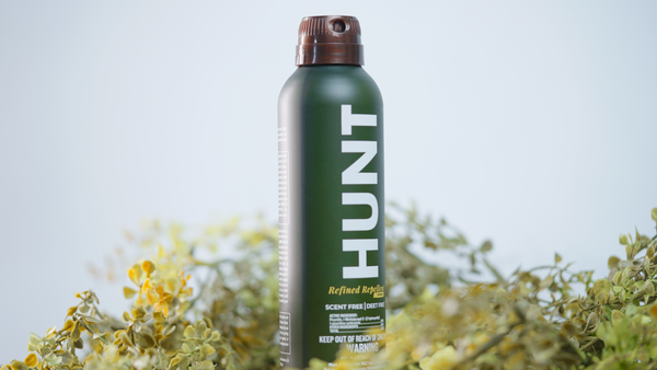 Hunt Refined Repellent Spray bottle with a natural background.