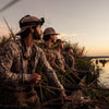Photo of hunters waiting for ducks in a field.