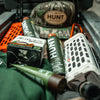 A photo of HUNT Refined Repellent among other hunting equipment.