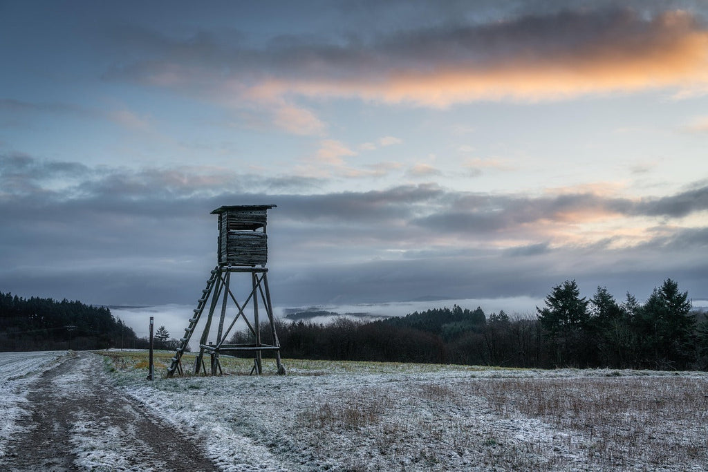 A photo of a hunting stand in a snowy field.