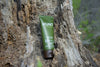 An image of a bottle of HUNT Repellent on a decaying tree stump.